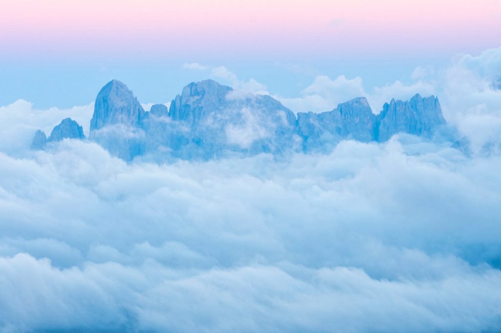 drone shot of foggy mountains during sunset