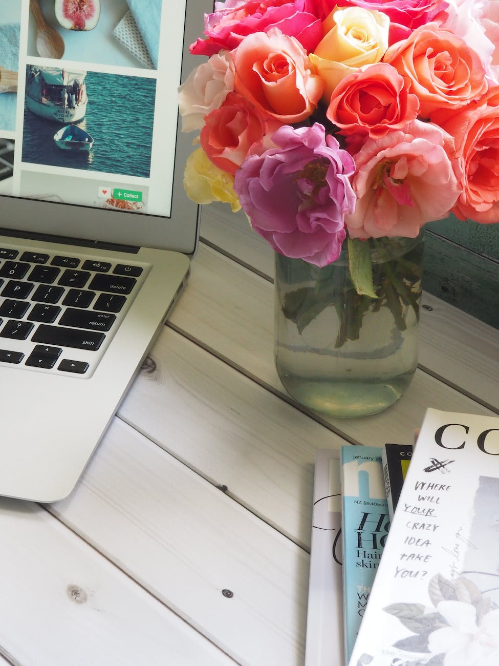 pexels-photo-839441 assorted color flower arrangement in clear glass vase beside a laptop
