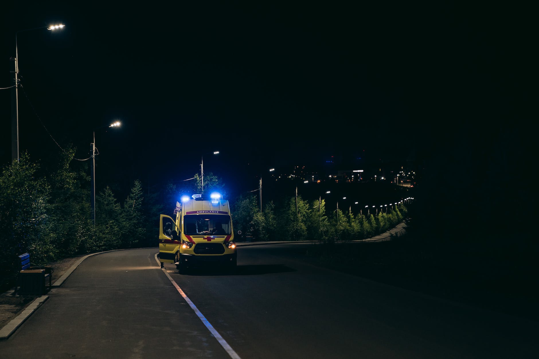 photo of an ambulance on the road at night