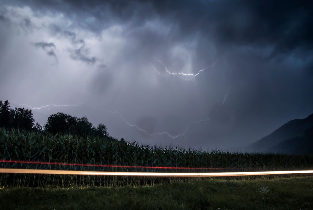 long exposure footage of road lights and a thunderstorm