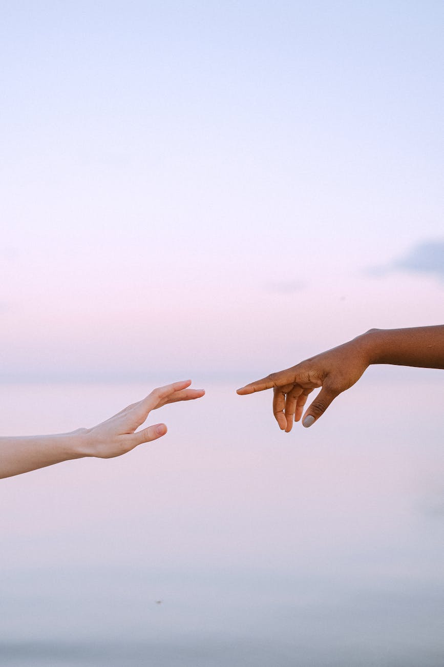 pexels-photo-4672714 photo of people reaching each other s hands