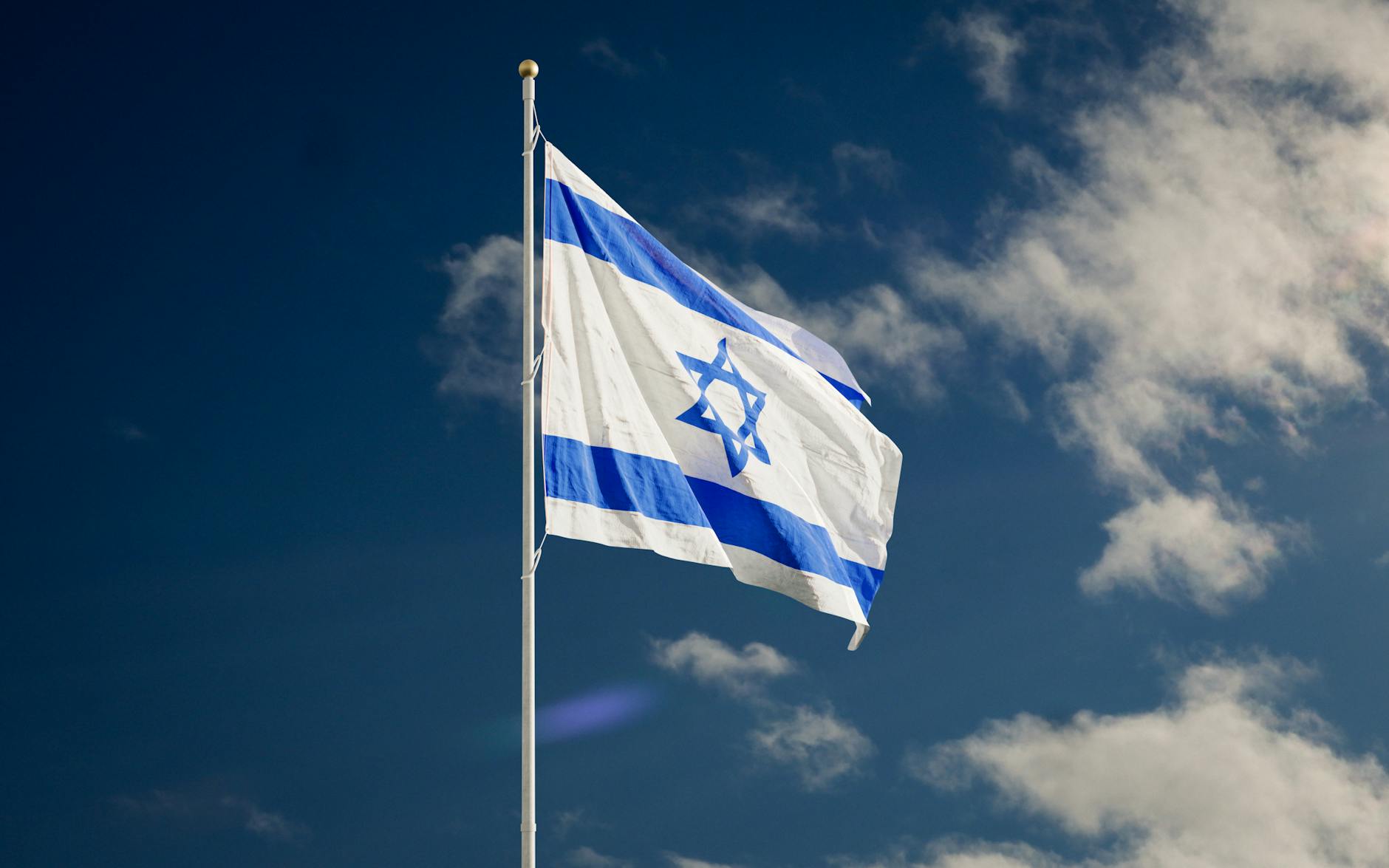 pexels-photo-5499191 israel flag on a flagpole under the blue sky