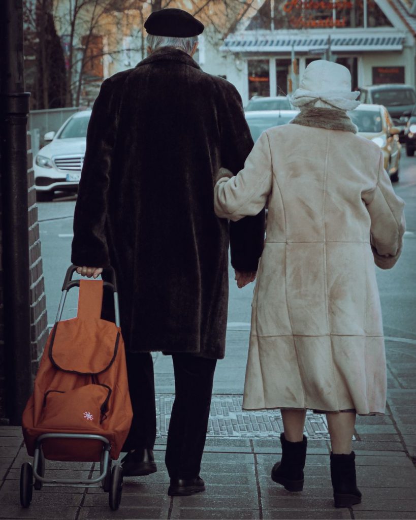 back view of an elderly couple walking together