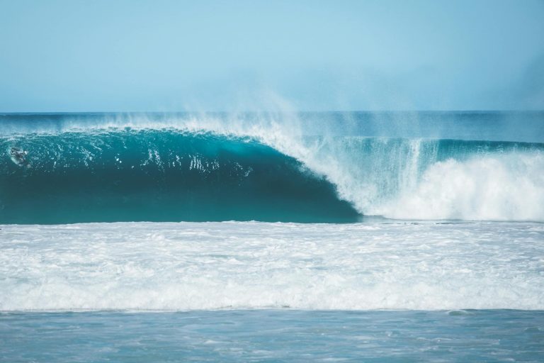 blue sea waves under cloudless sky