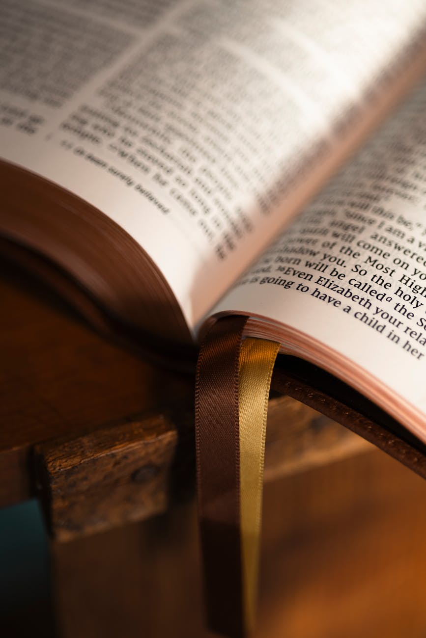 open bible with bookmarks on wooden stand