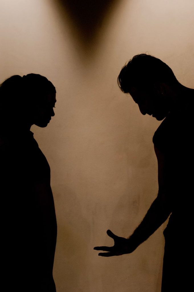 dramatic silhouette of couple in argument
