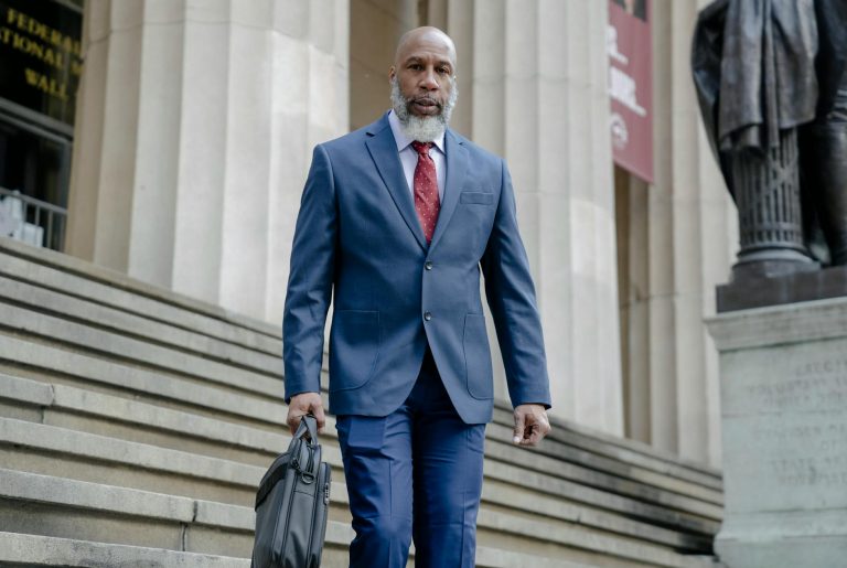 confident african american manager in formal suit going downstairs