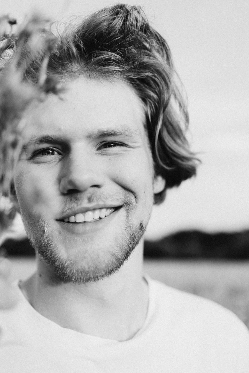 man in white crew neck shirt smiling