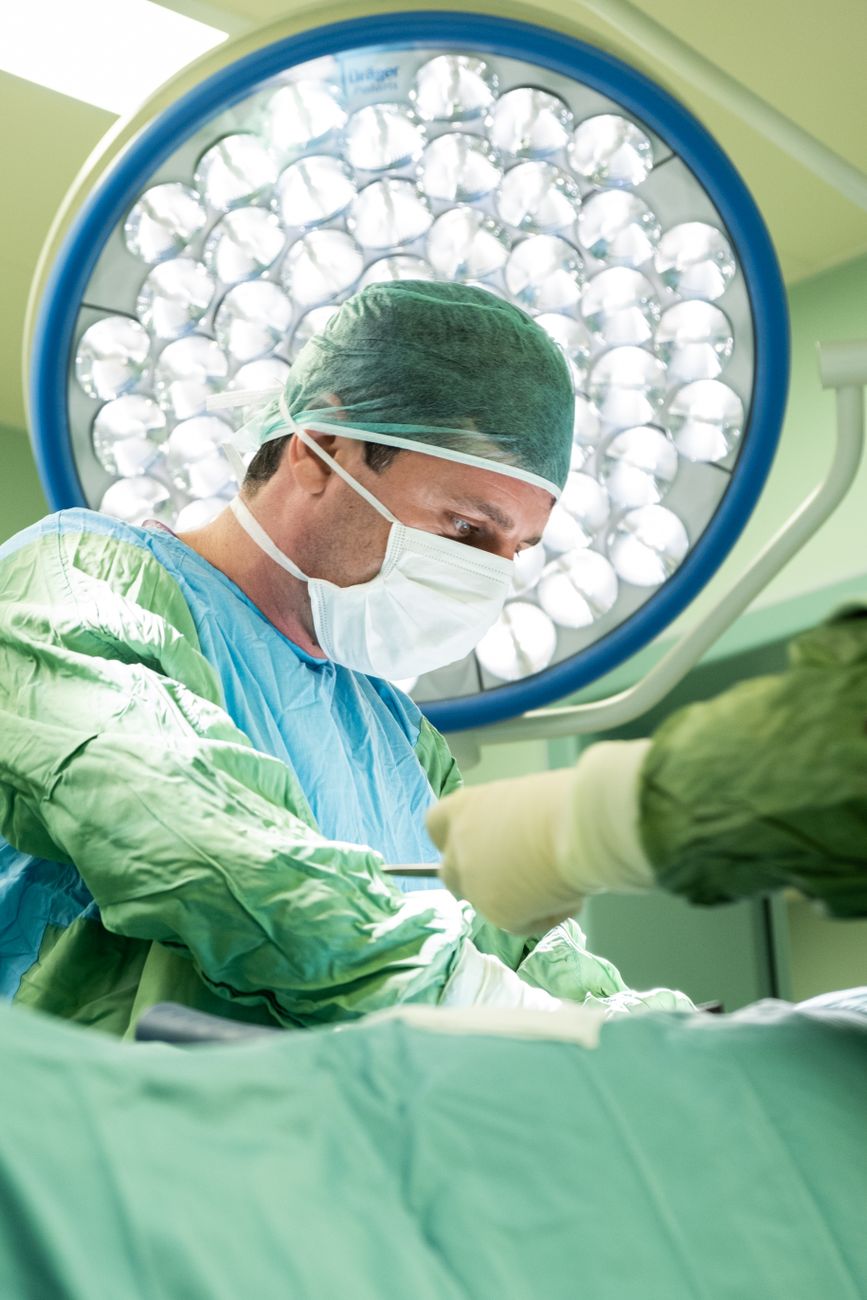 surgeon performing operation in modern operating room